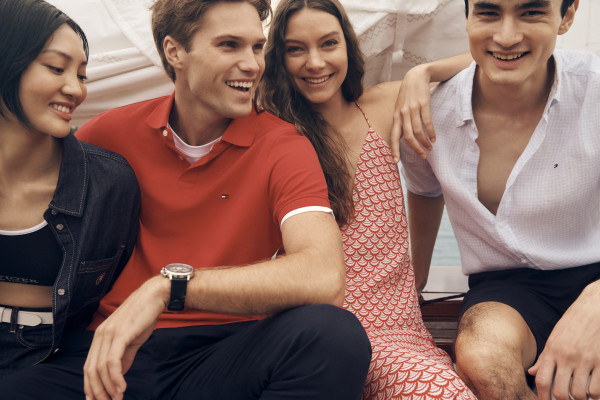 Models wear new summer Tommy Hilfiger clothes on a boat