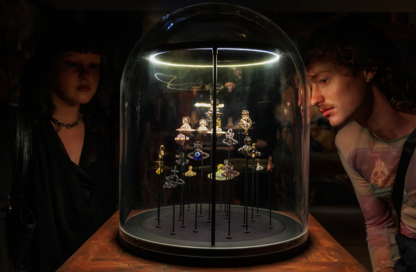 Man and woman admiring Vivienne Westwood orbs at the Vivienne Westwood &amp;amp;amp;amp;amp;amp;amp;amp;amp;amp;amp; Jewellery exhibition at Te Papa, Wellington, New Zealand